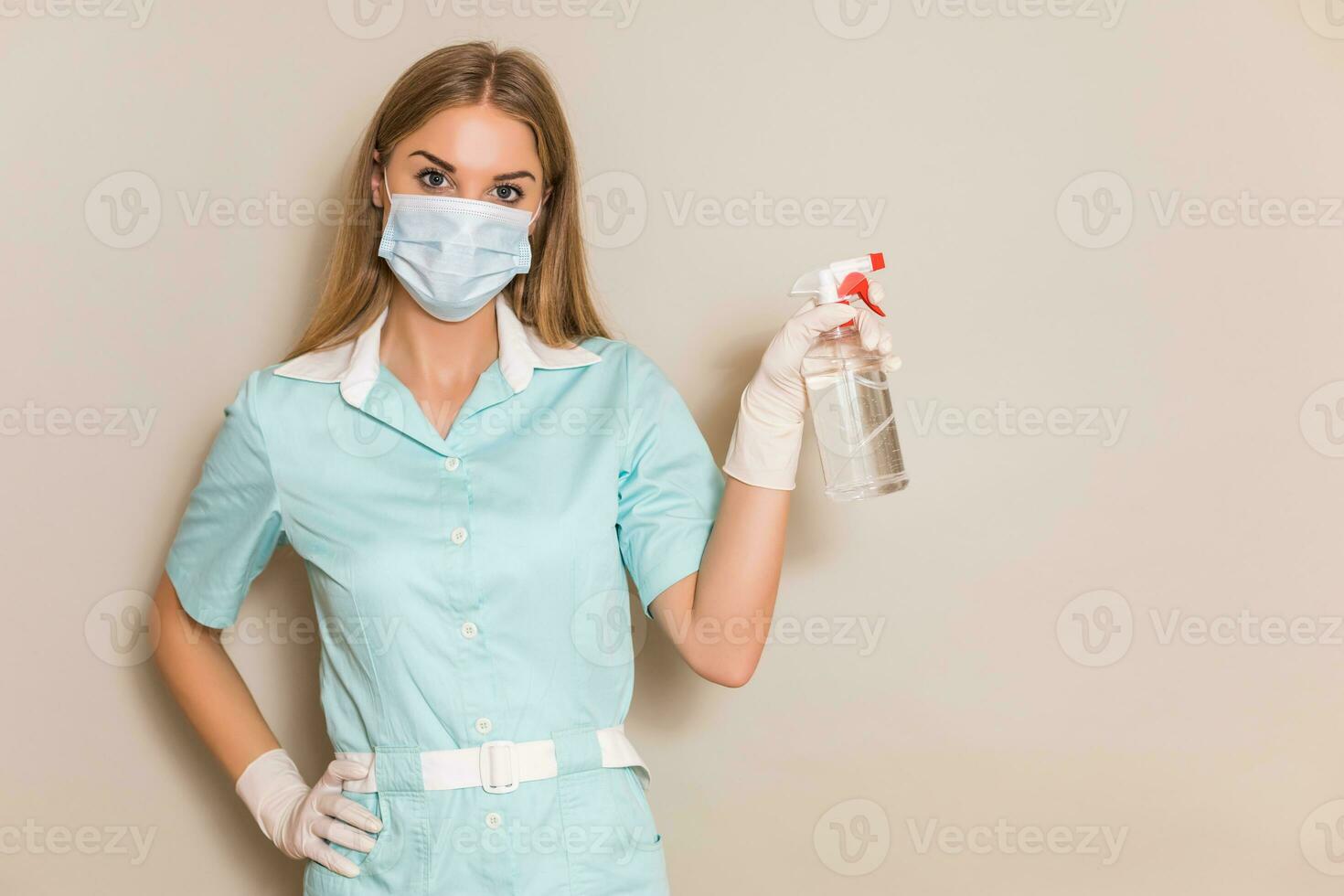 Portrait of medical nurse holding alcohol spray. photo