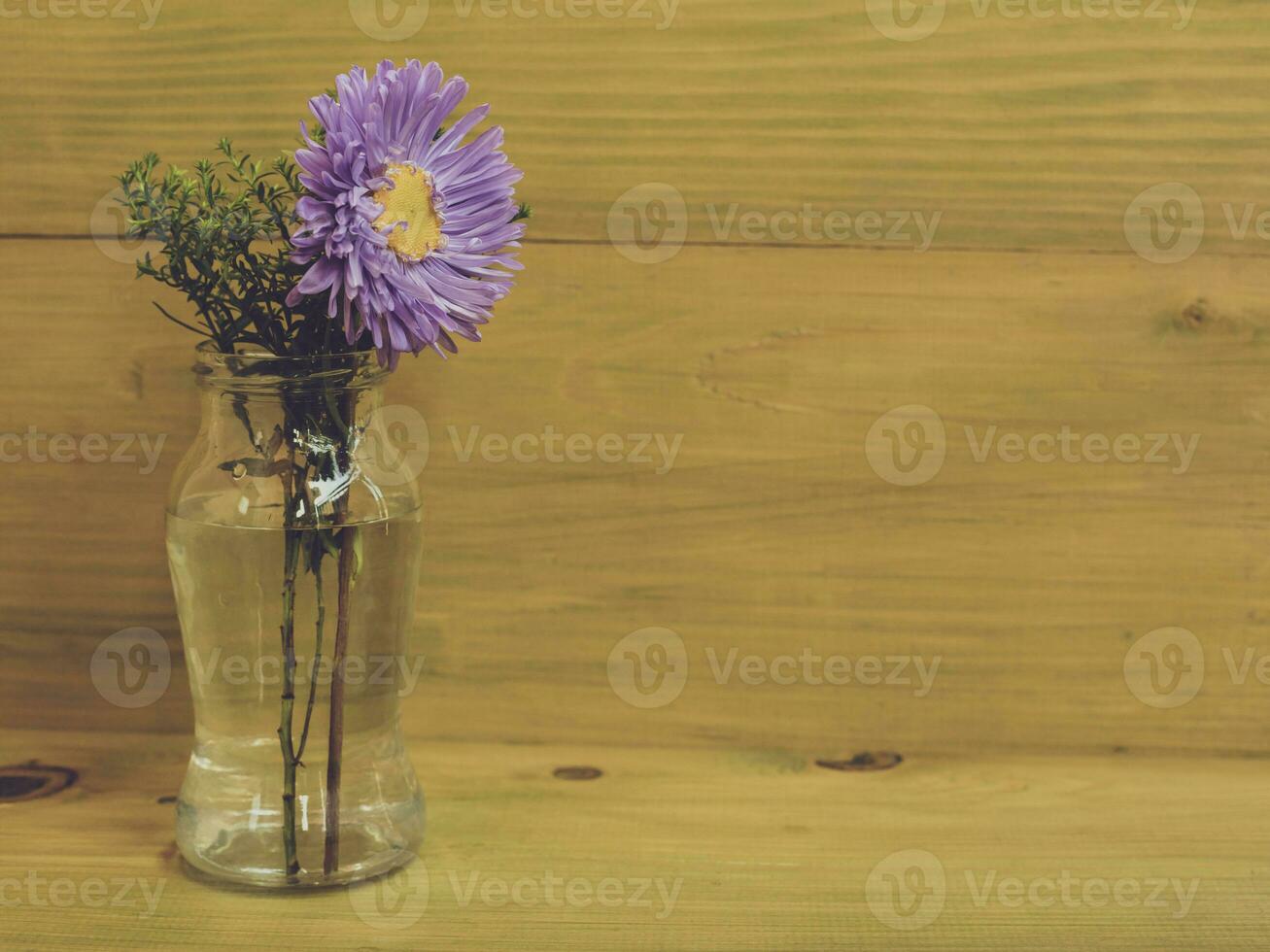Image of vase with beautiful flowers on wooden background. photo