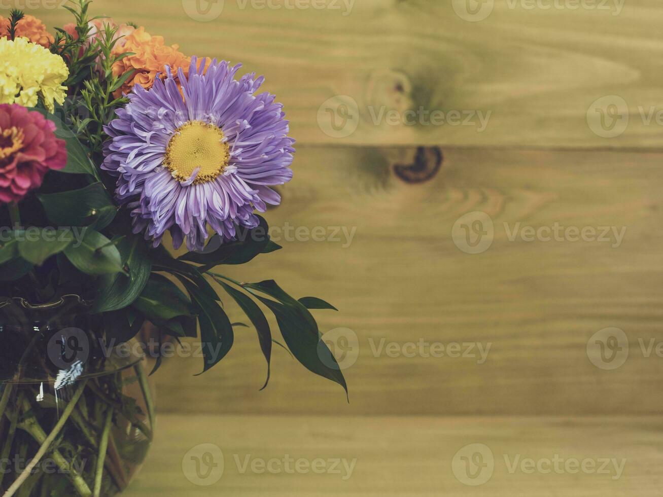 Image of vase with beautiful flower on wooden background. photo