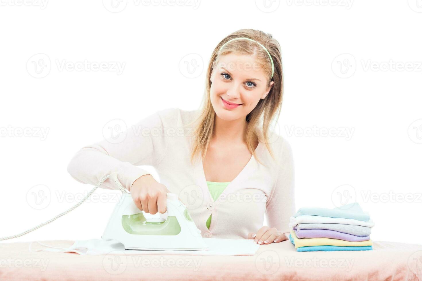 Happy housewife ironing photo