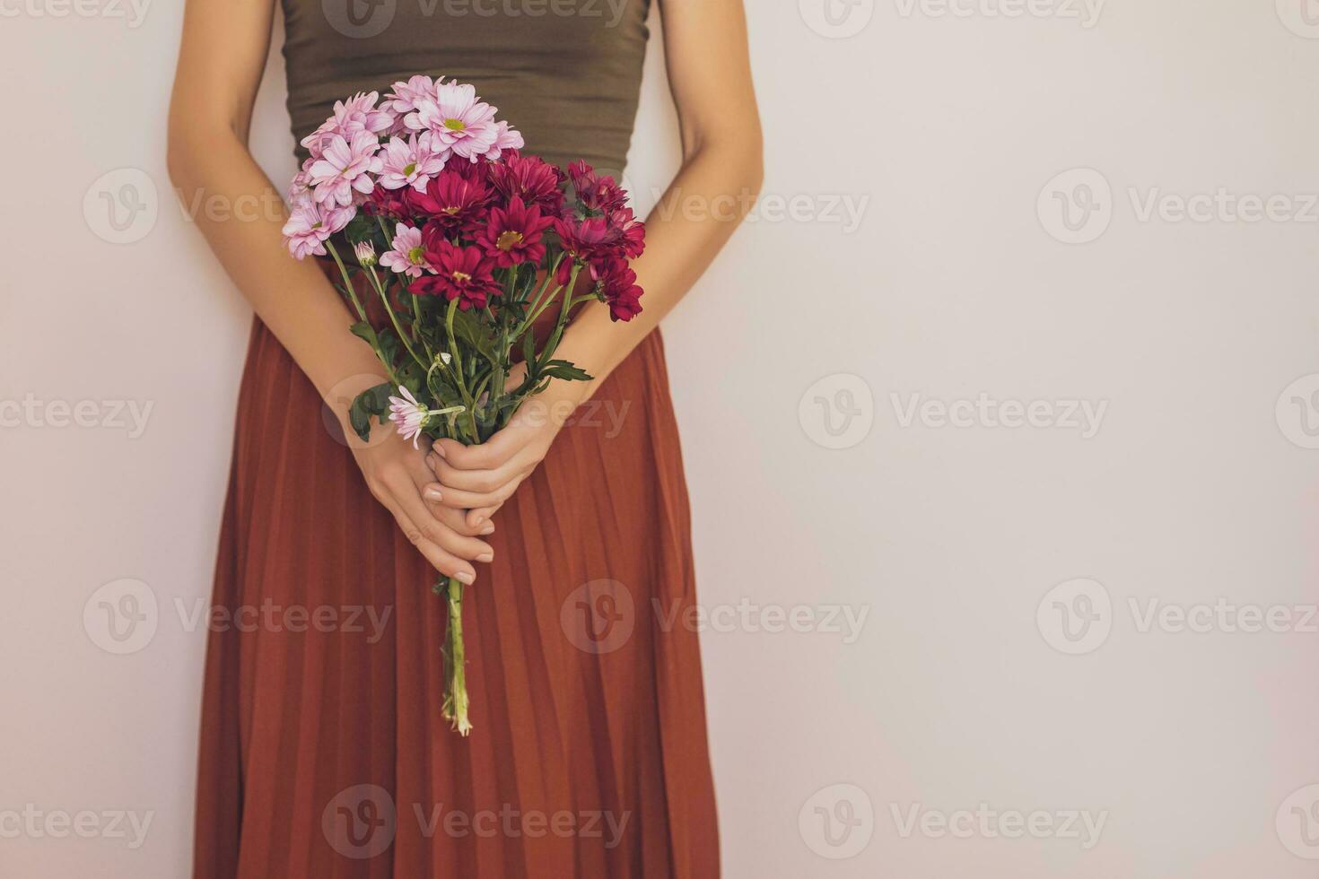 Woman holding beautiful bouquet of flowers.Focus on flowers. photo