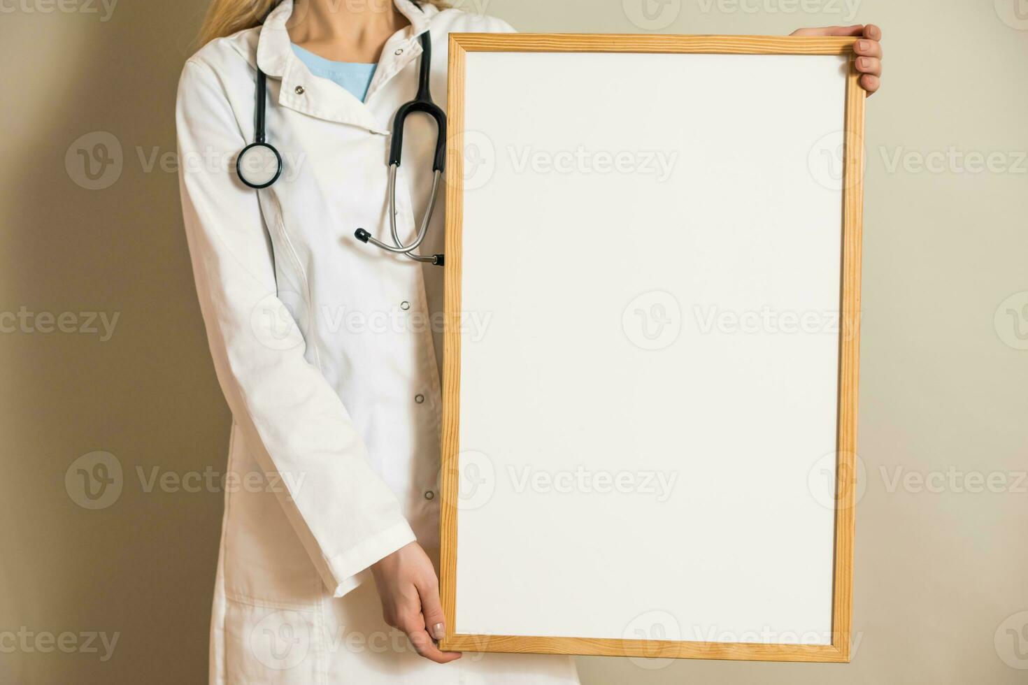 Image of female doctor holding white board. photo
