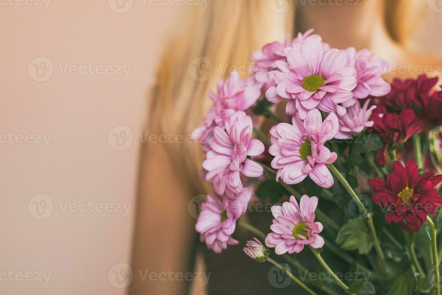 Woman holding beautiful bouquet of flowers.Focus on flowers. photo