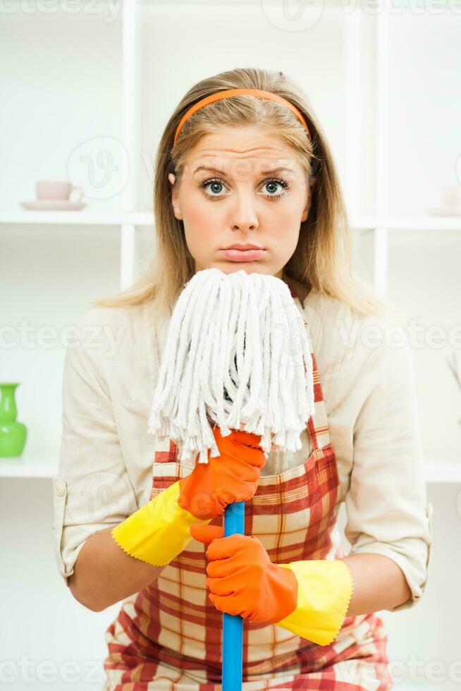 Exhausted housewife cleaning photo
