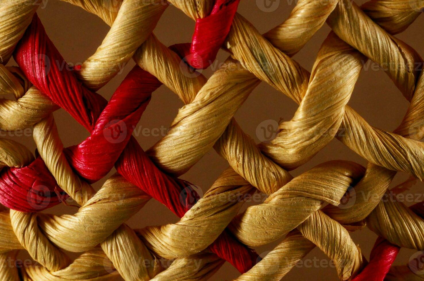 close up of a woven basket with red and gold thread photo