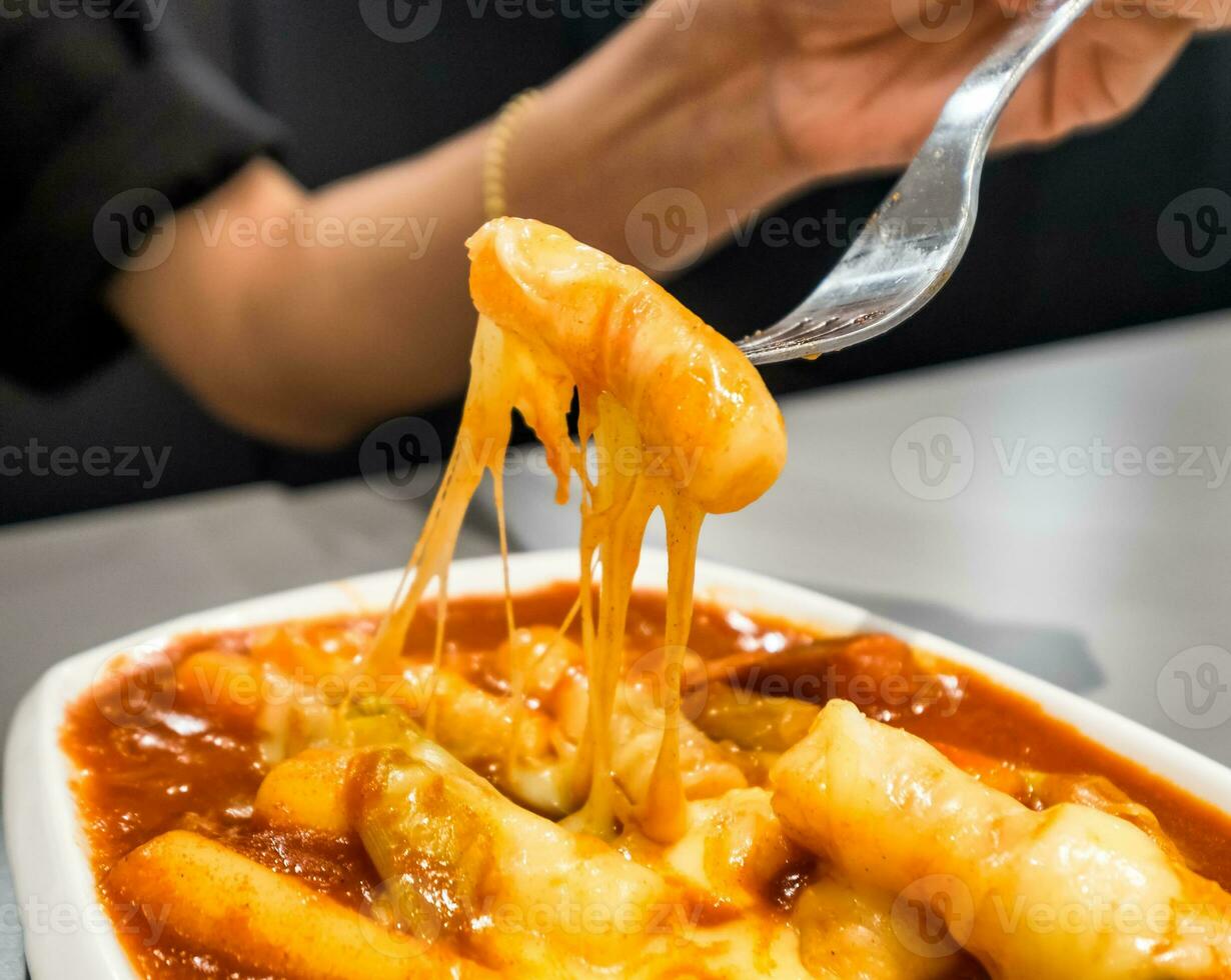 Women holding fork with tteokbokki cheese photo