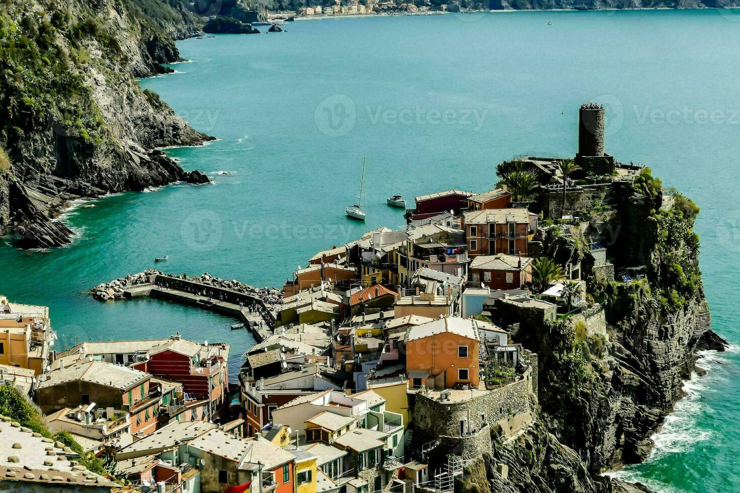 the town of cinque terre is perched on the edge of a cliff photo