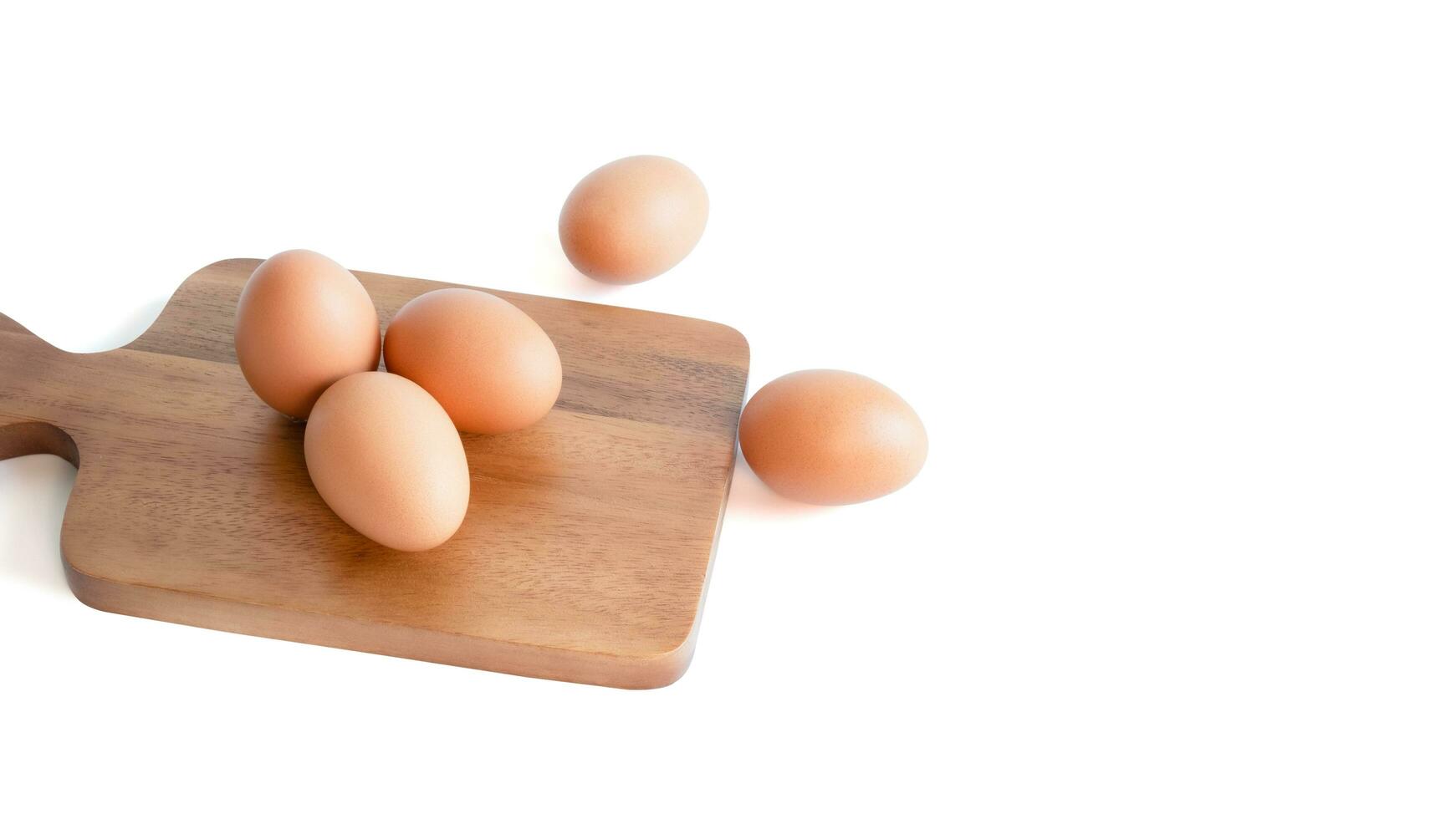 fresh organic chicken eggs. on brown cutting board, photo