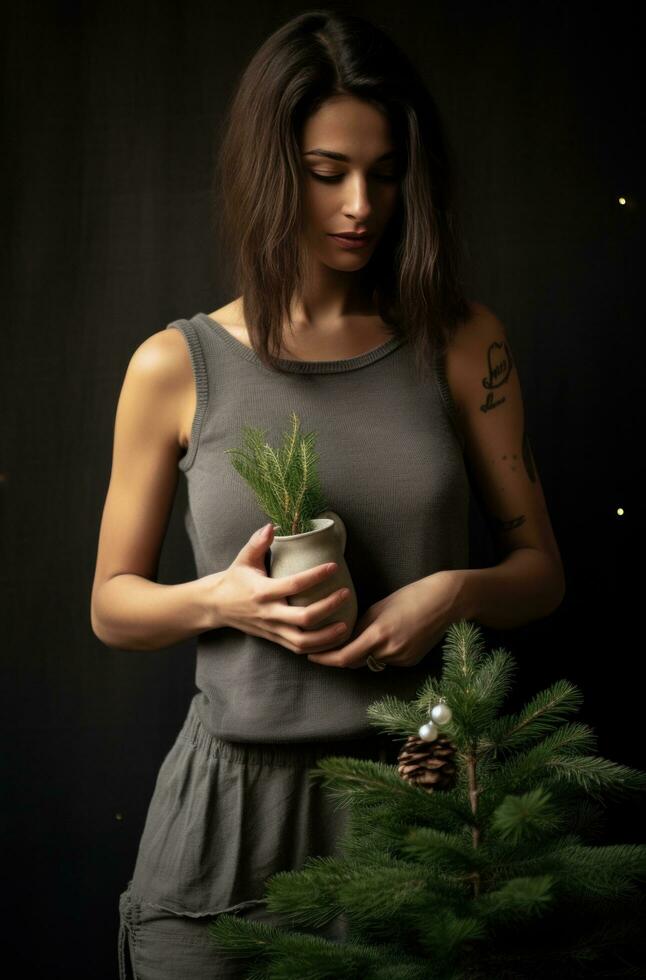 ai generado un mujer participación un Navidad árbol y tanque parte superior foto