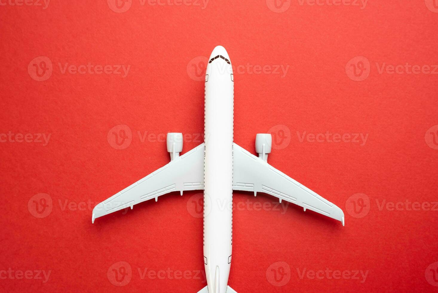 Airline plane top view on red background. Passenger transportation. Business and tourism. Airline. World communication and commercial flights. Arrival and departure. photo
