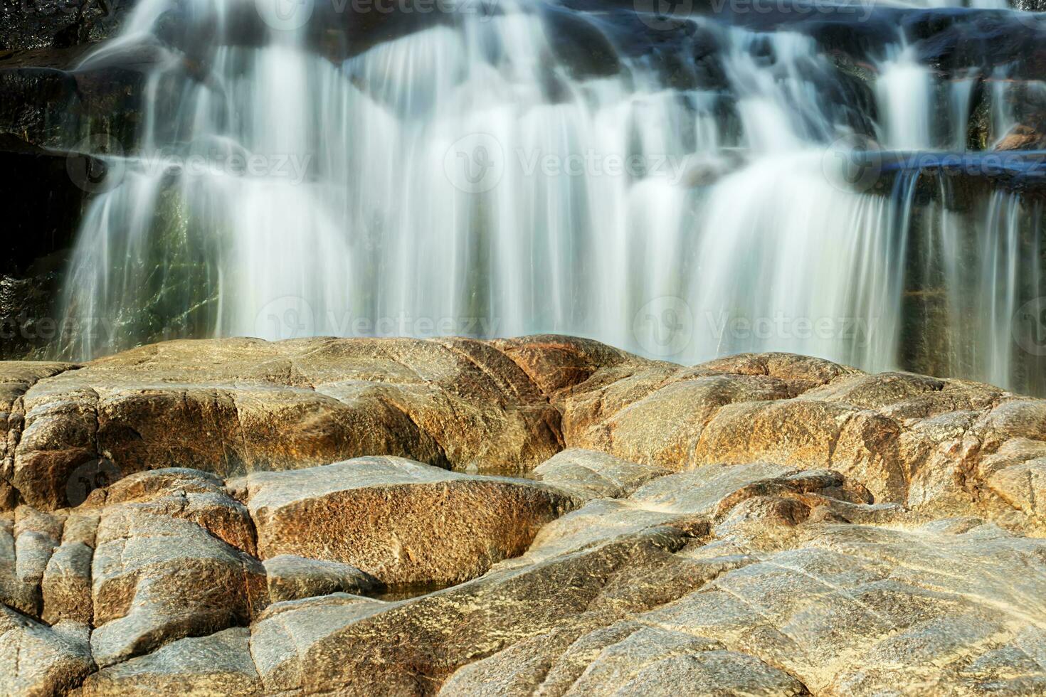 Small waterfall and stone with water motion. photo