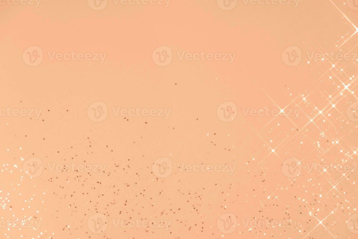 Abstract Peach Fuzz background with sparkles in the shape of stars. photo