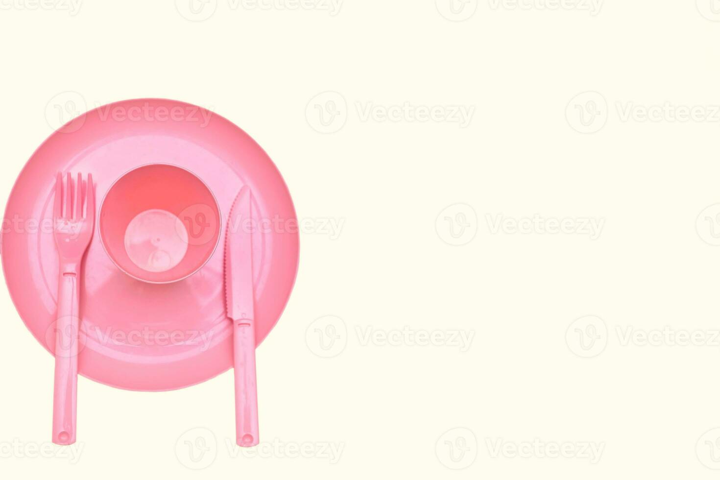Pink plastic cup, plate, fork,knife for camping, isolated on white photo