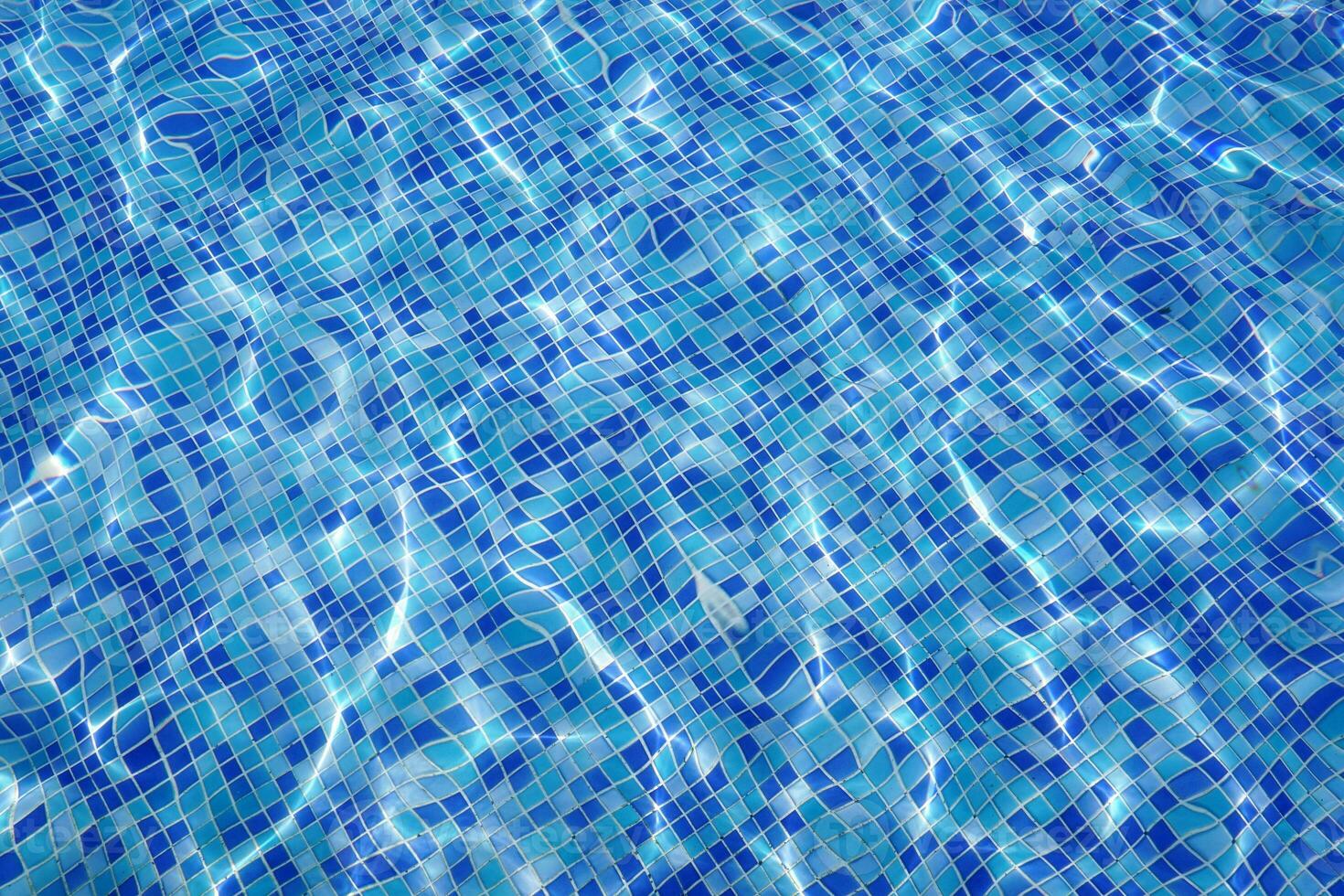 defocus blurred blue water in pool rippled water background. Swimming pool texture, water wave under texture background. photo