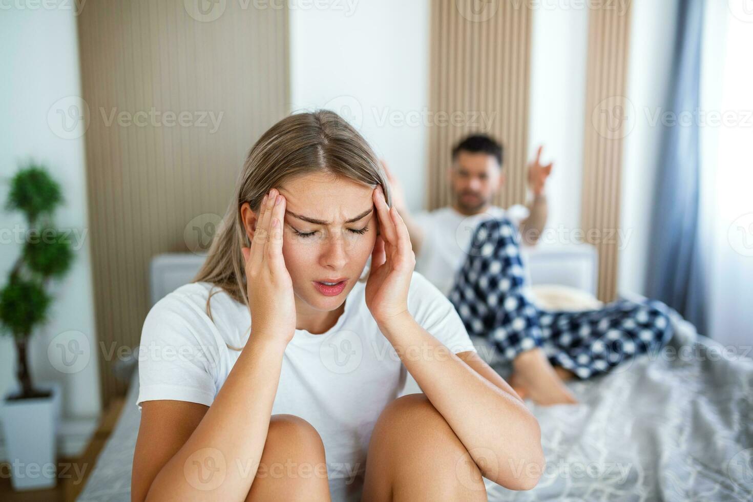 Frustrated sad girlfriend sit on bed think of relationship problems, thoughtful couple after quarrel lost in thoughts, upset lovers consider break up, offended person disappointed by boyfriend photo