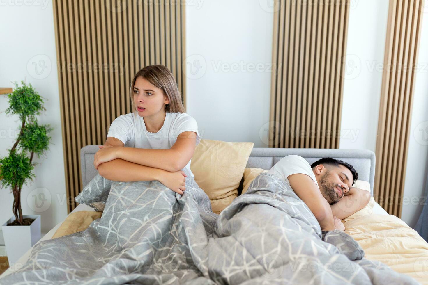 Frustrated sad girlfriend sit on bed think of relationship problems, thoughtful couple after quarrel lost in thoughts, upset lovers consider break up, offended person disappointed by boyfriend photo