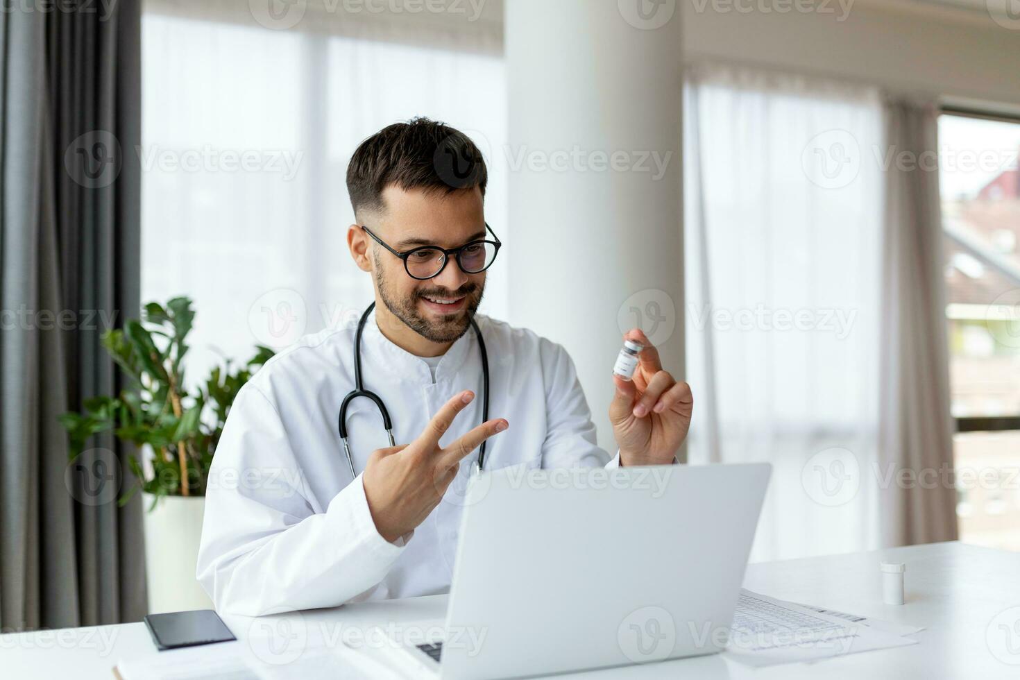 Happy young GP doctor holding distant web camera meeting, giving professional consultation to patient using computer video call app, virtual healthcare event concept. photo