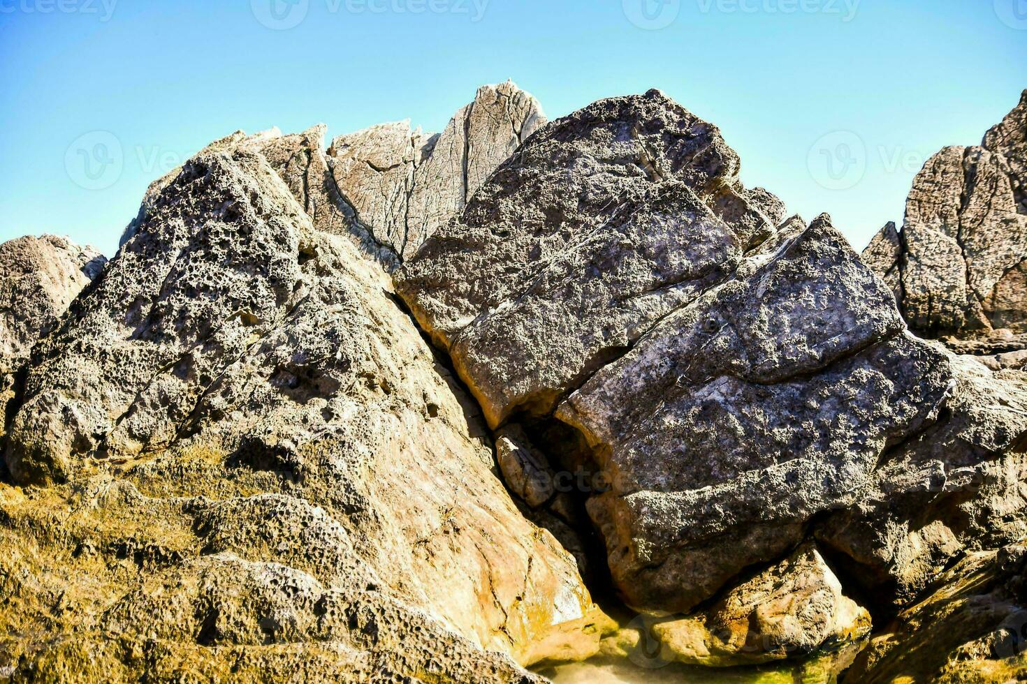 the rocks at the beach are very large photo