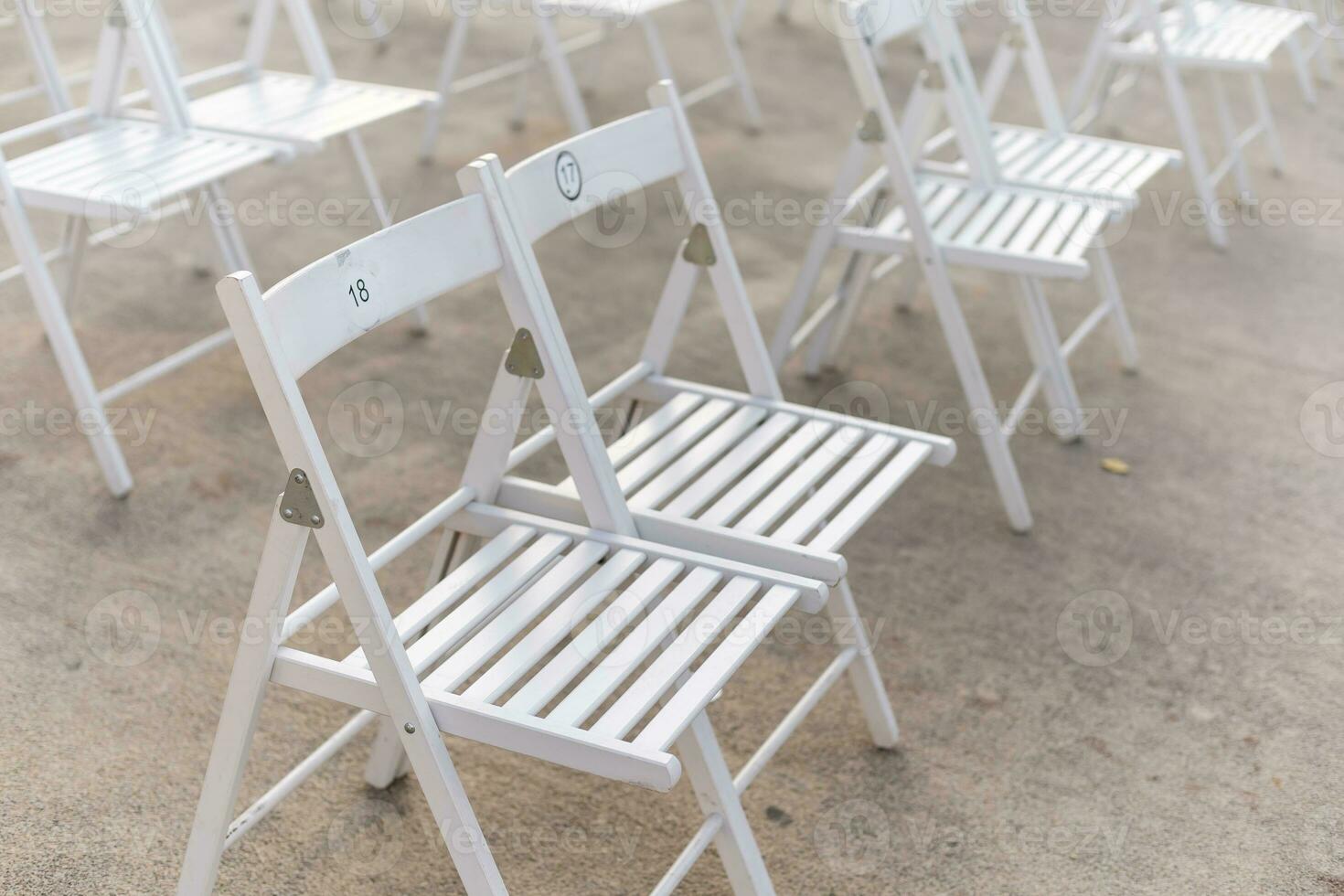 Rows of empty metal chair seats installed for some business event or performance,festival photo