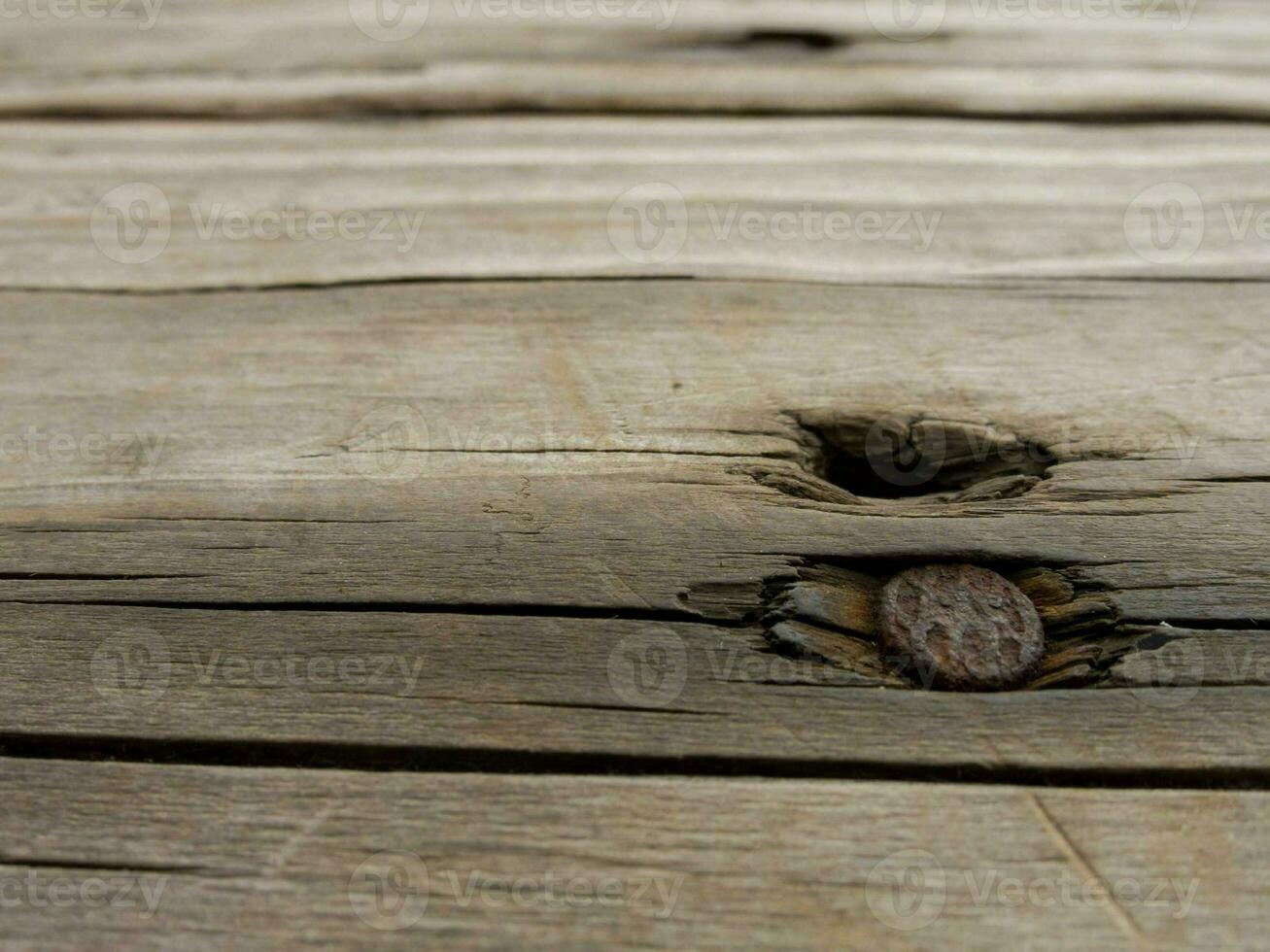a close up of a wooden plank with a hole in it photo