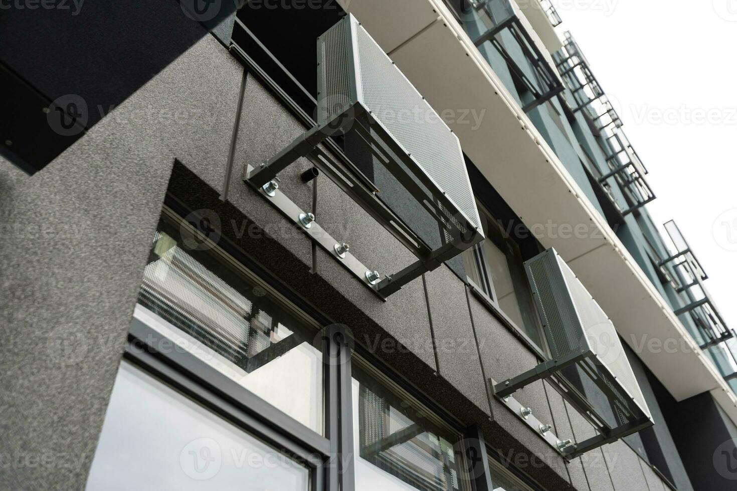Abstract fragment of modern architecture, gray walls, glass and concrete. photo