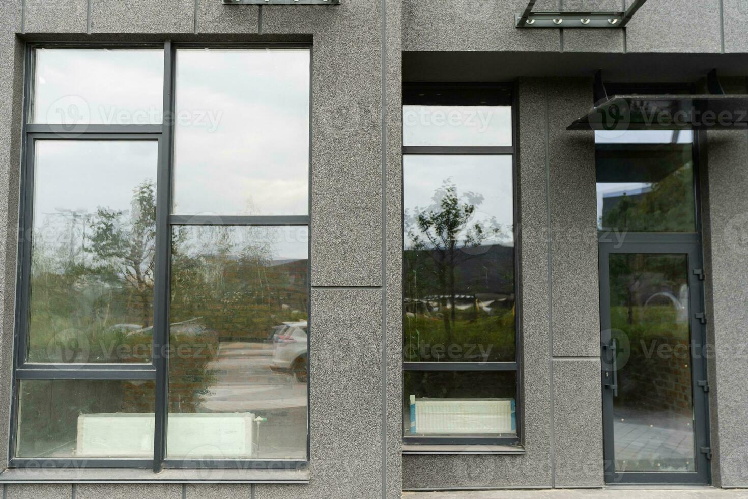 Abstract fragment of modern architecture, gray walls, glass and concrete. photo