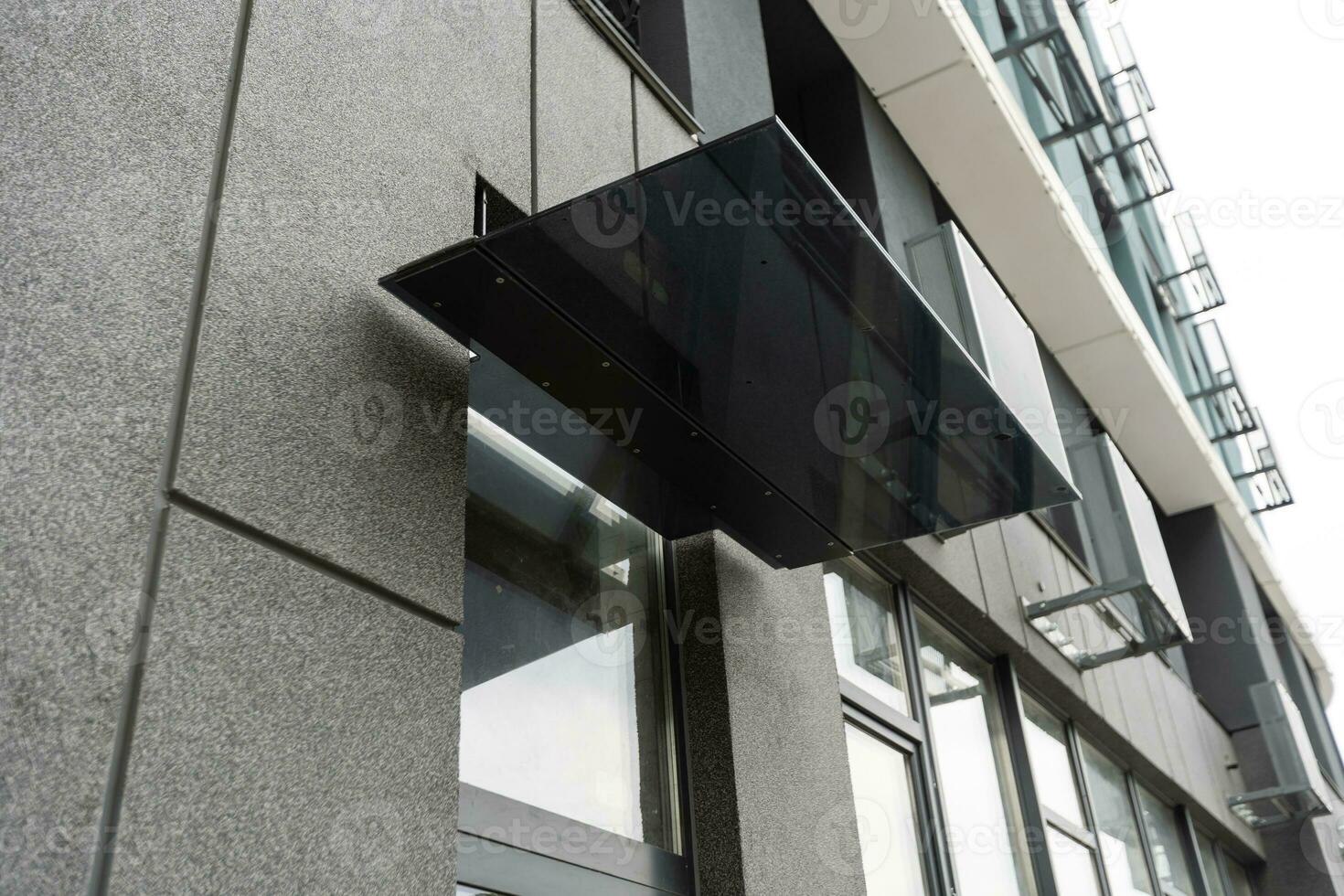 Abstract fragment of modern architecture, gray walls, glass and concrete. photo