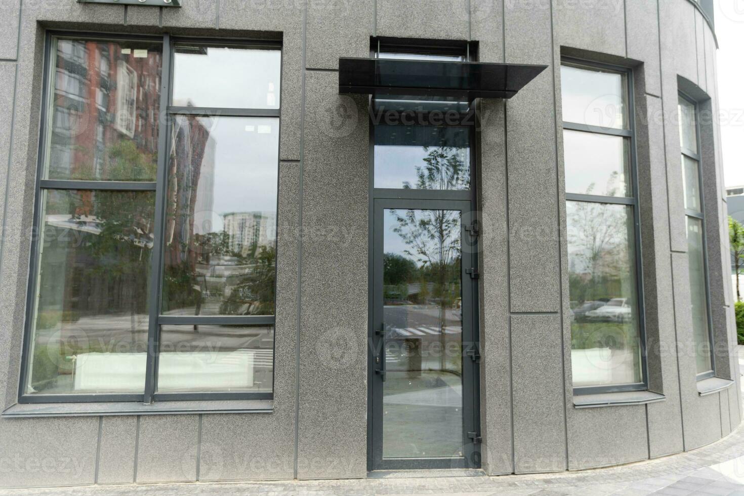 Abstract fragment of modern architecture, gray walls, glass and concrete. photo