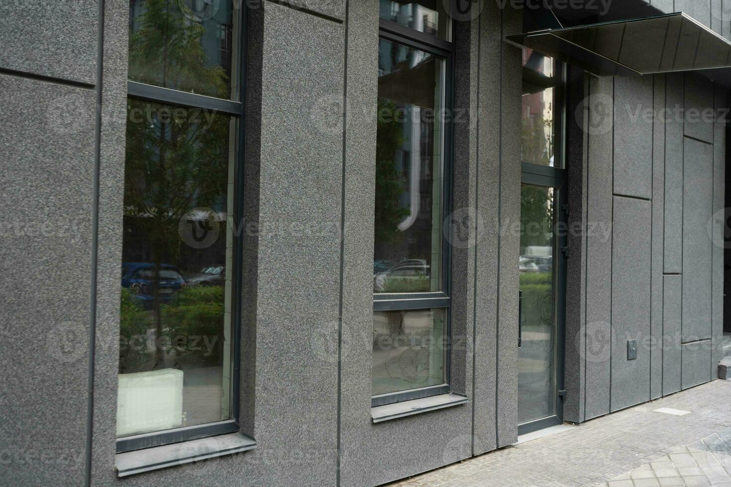 Abstract fragment of modern architecture, gray walls, glass and concrete. photo