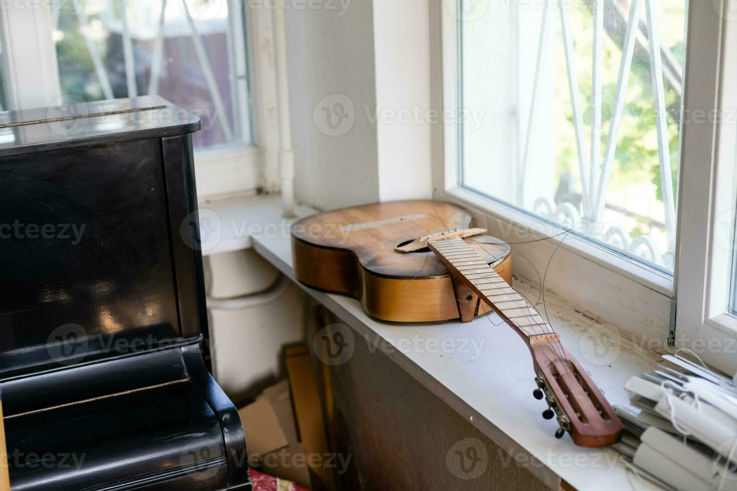 Old dusty guitar in an old house. Spruce dreadnought acoustic guitar. Guitar on background. photo