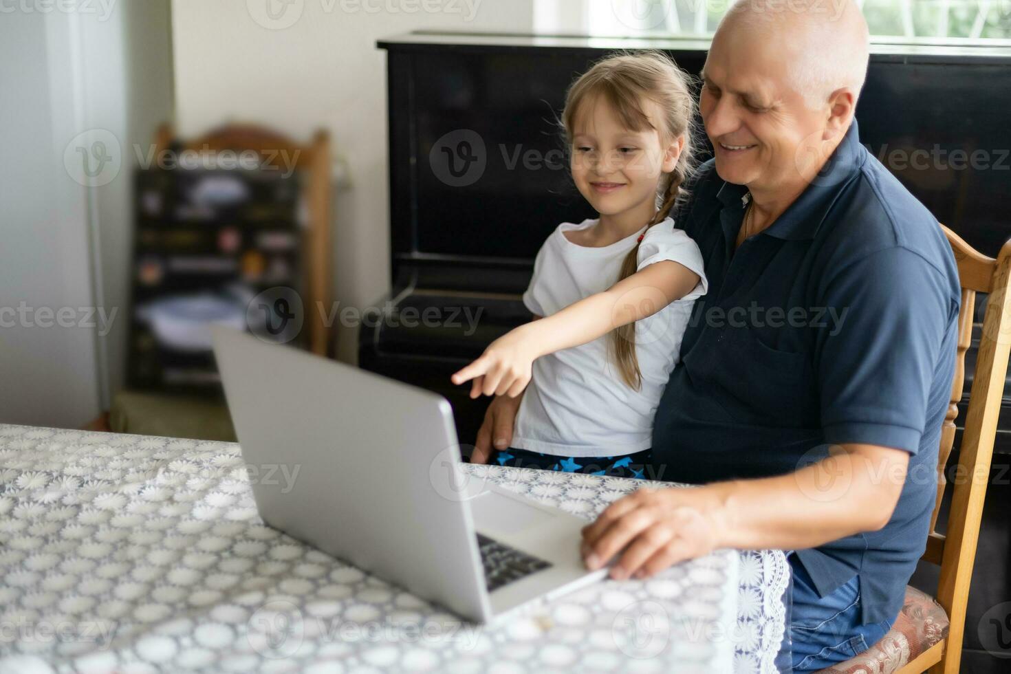 Photo of funny two people old grandpa little interested granddaughter sitting sofa telling good story stay house quarantine safety modern design interior living room indoors