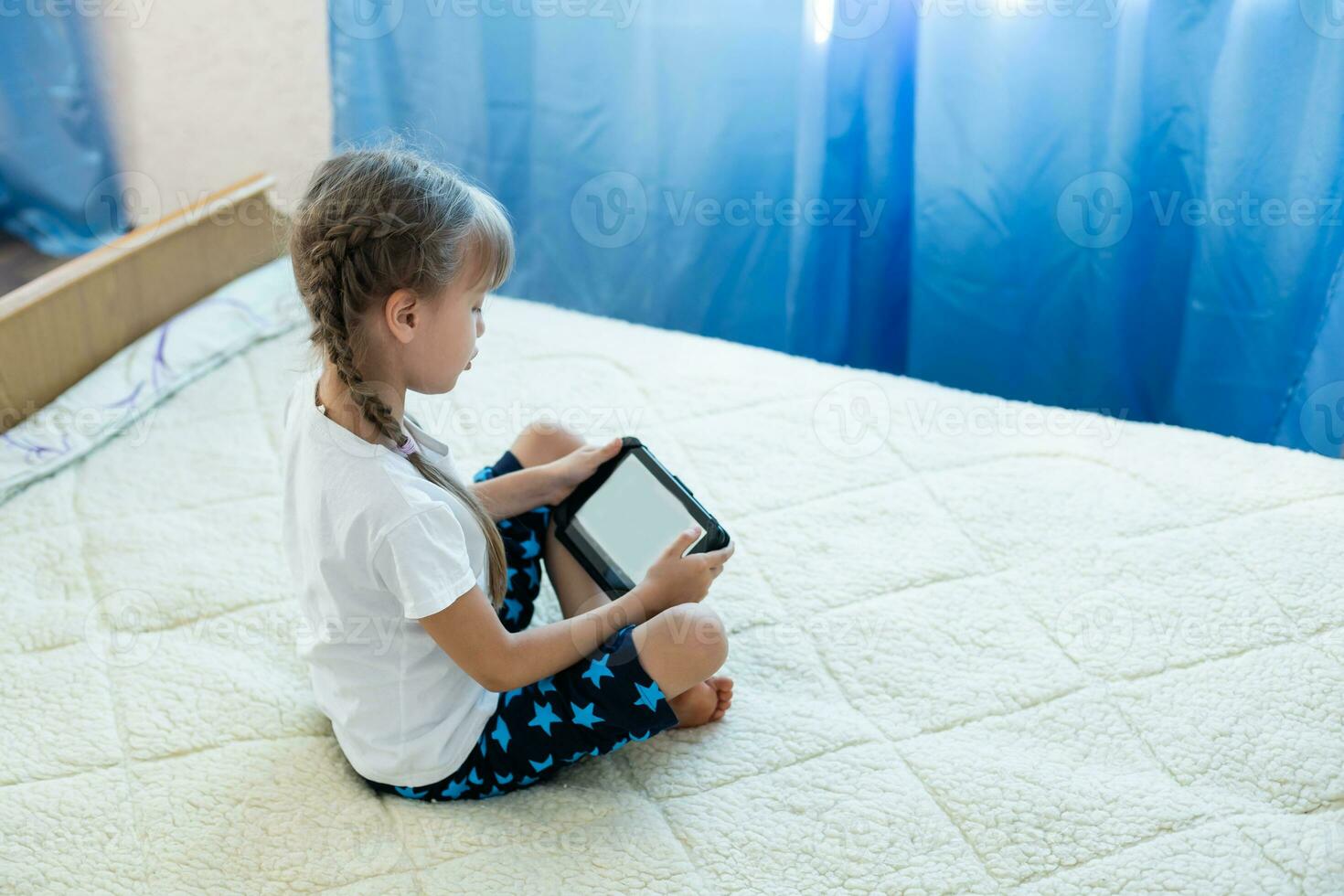 Remote lessons. The child smiles happily and gets knowledge remotely. Little girl study online learning from home with laptop. Online school. photo