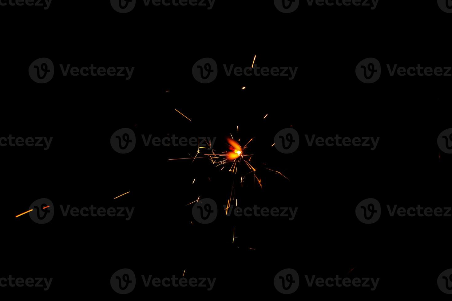 A lit sparkler showing bright sparks photo