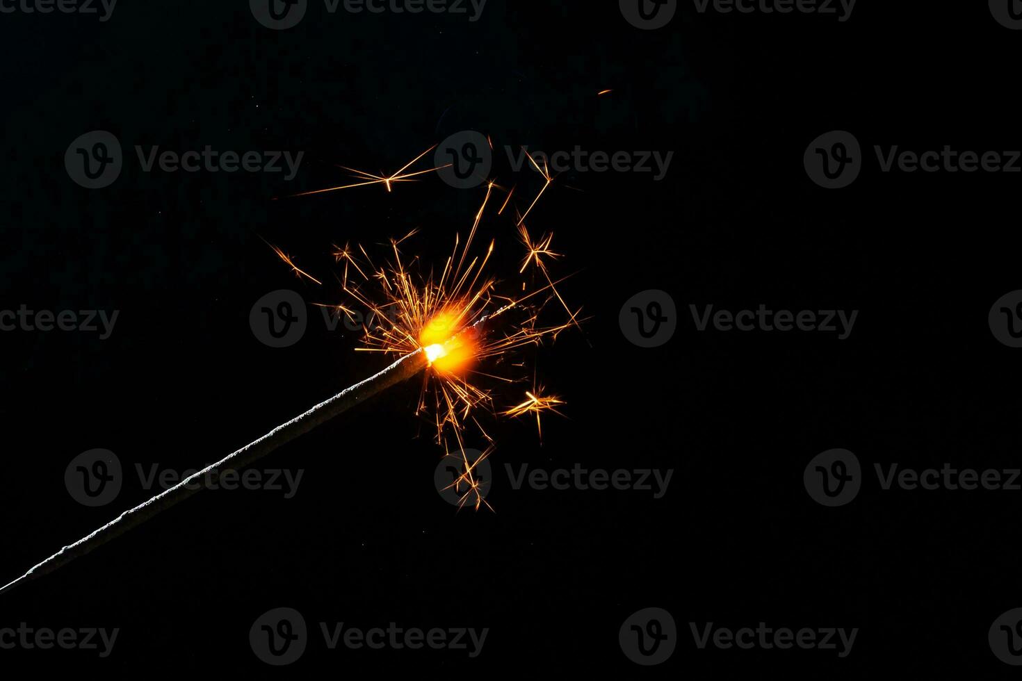 A lit sparkler showing bright sparks photo