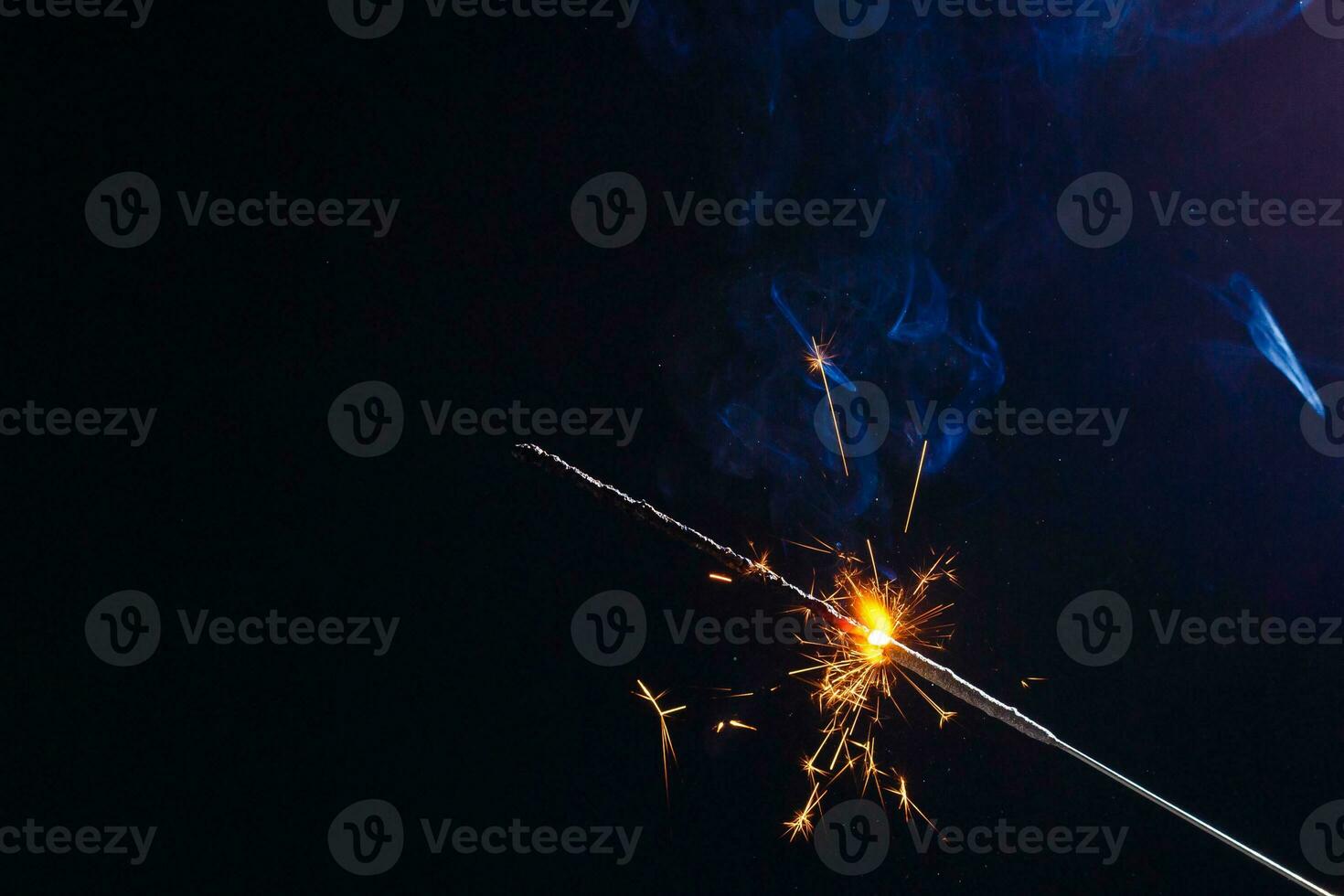 A lit sparkler showing bright sparks photo