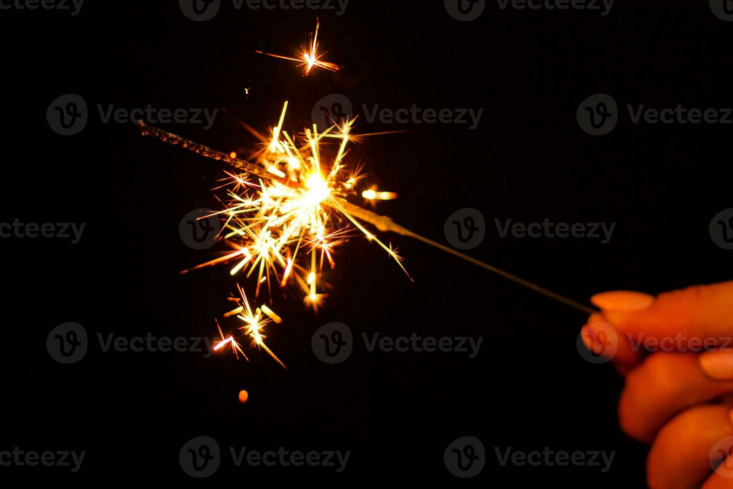 A lit sparkler showing bright sparks photo