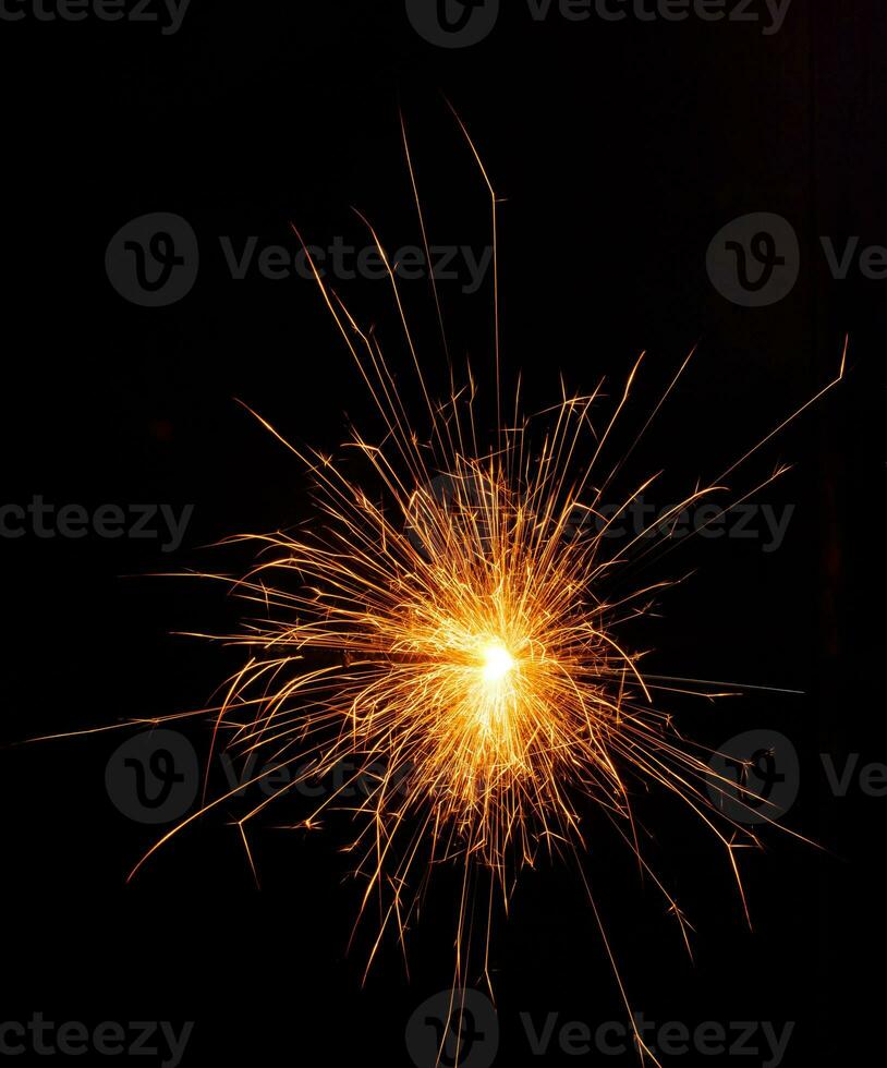 A lit sparkler showing bright sparks photo