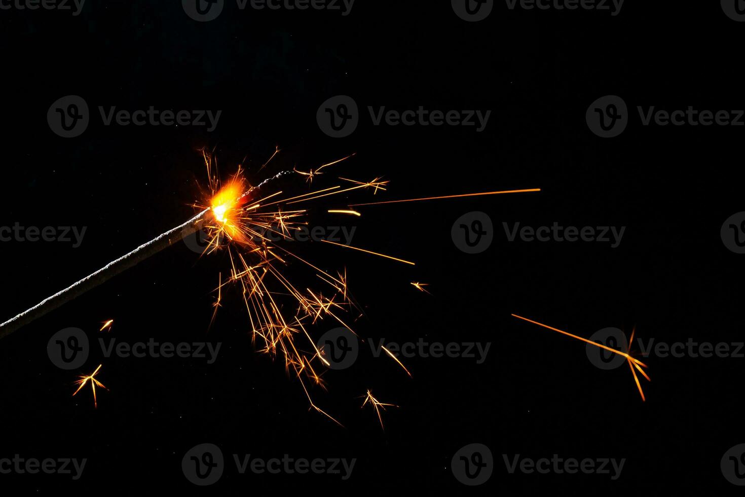 A lit sparkler showing bright sparks photo