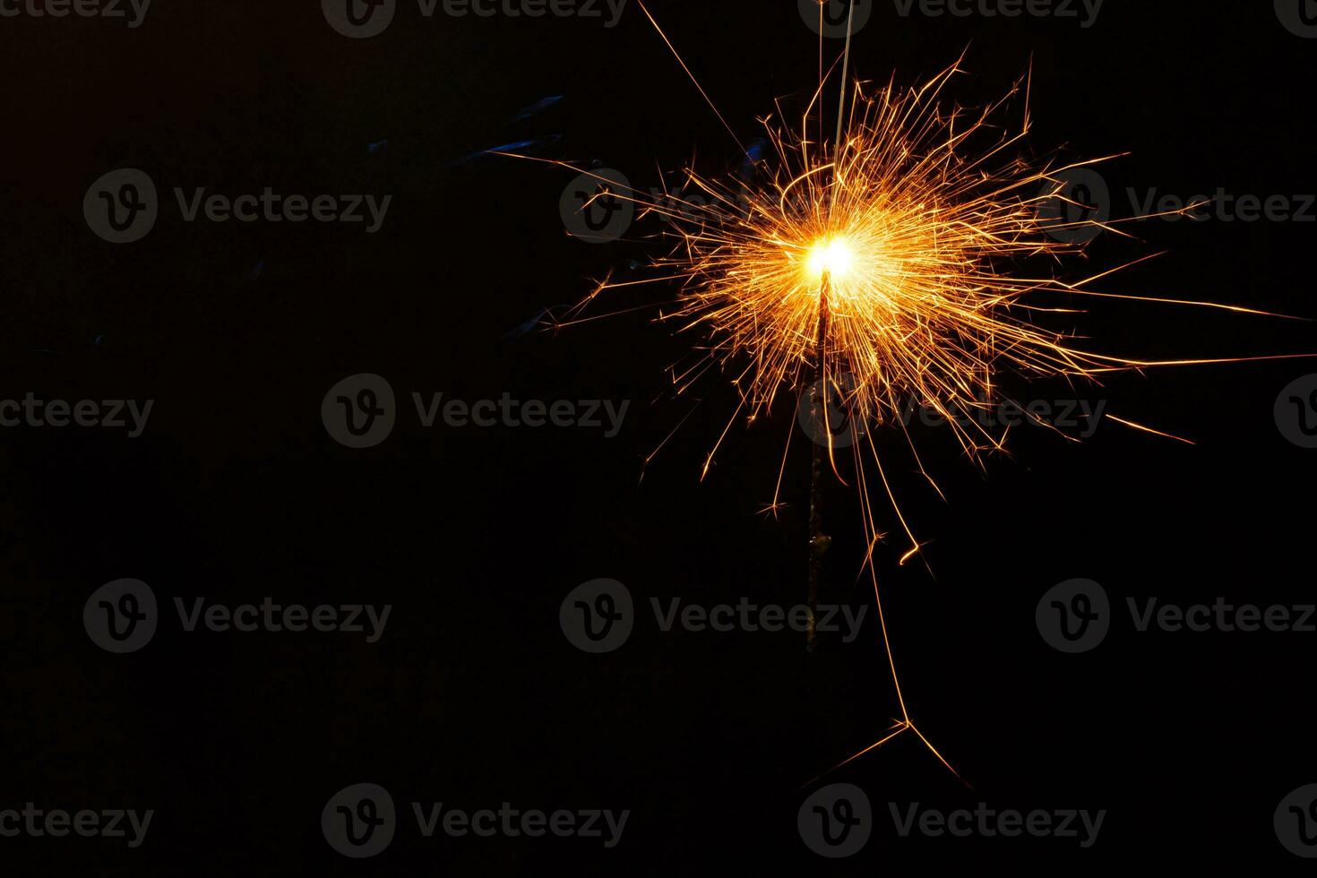 A lit sparkler showing bright sparks photo