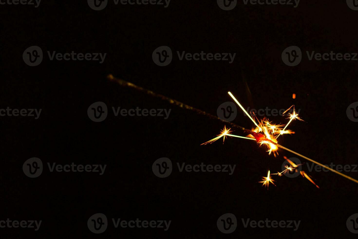 A lit sparkler showing bright sparks photo