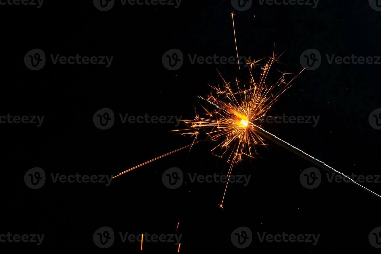 A lit sparkler showing bright sparks photo