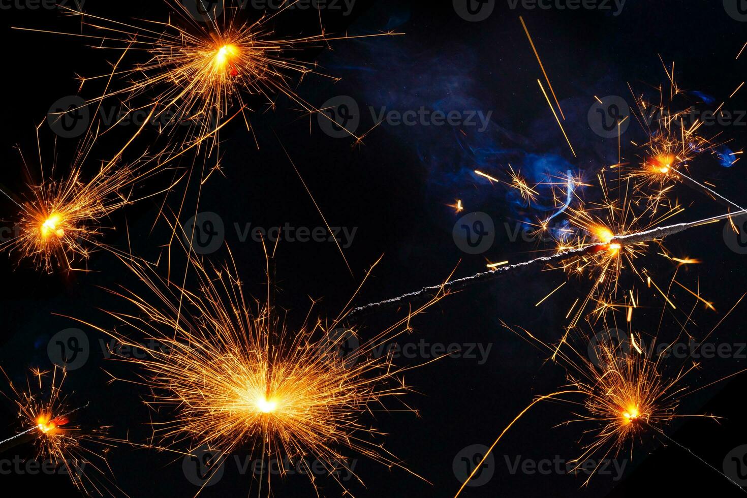 A lit sparkler showing bright sparks photo
