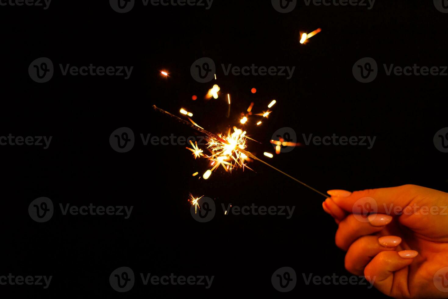 A lit sparkler showing bright sparks photo