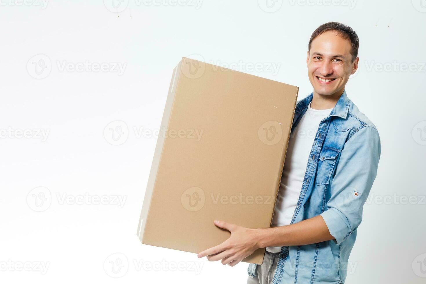 Smiling delivery man giving cardbox on white background photo