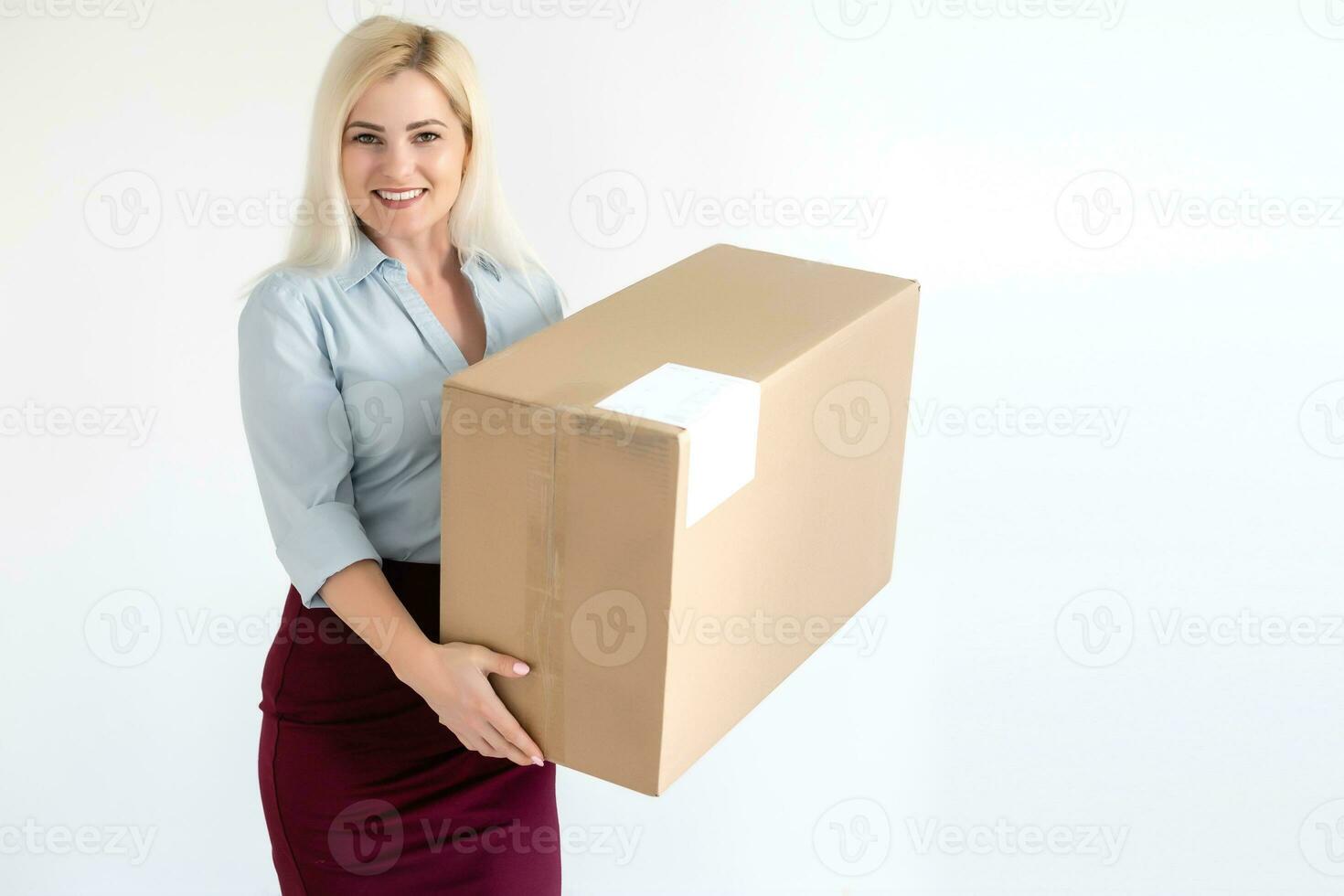 A young beautiful caucasian woman holding a box in her hands. photo