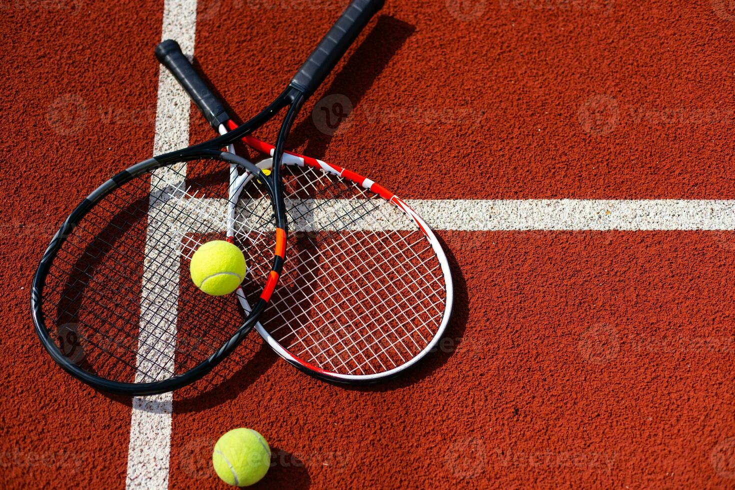 A tennis racket and new tennis ball on a freshly painted tennis court photo