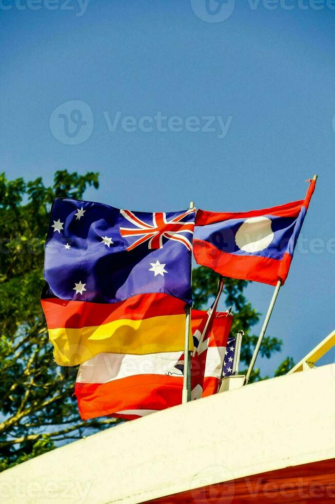 a group of flags flying in the wind photo