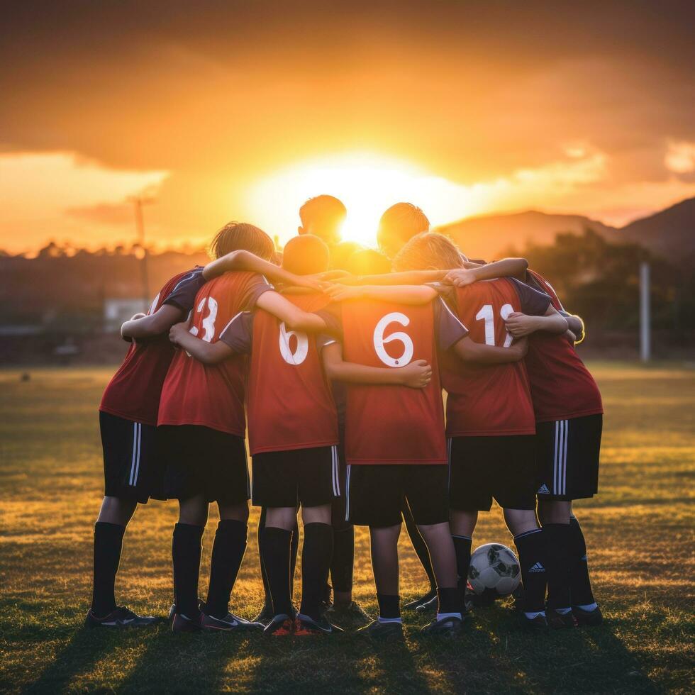 AI generated A group of young soccer players huddled together in a team talk, with the sun setting behind them photo