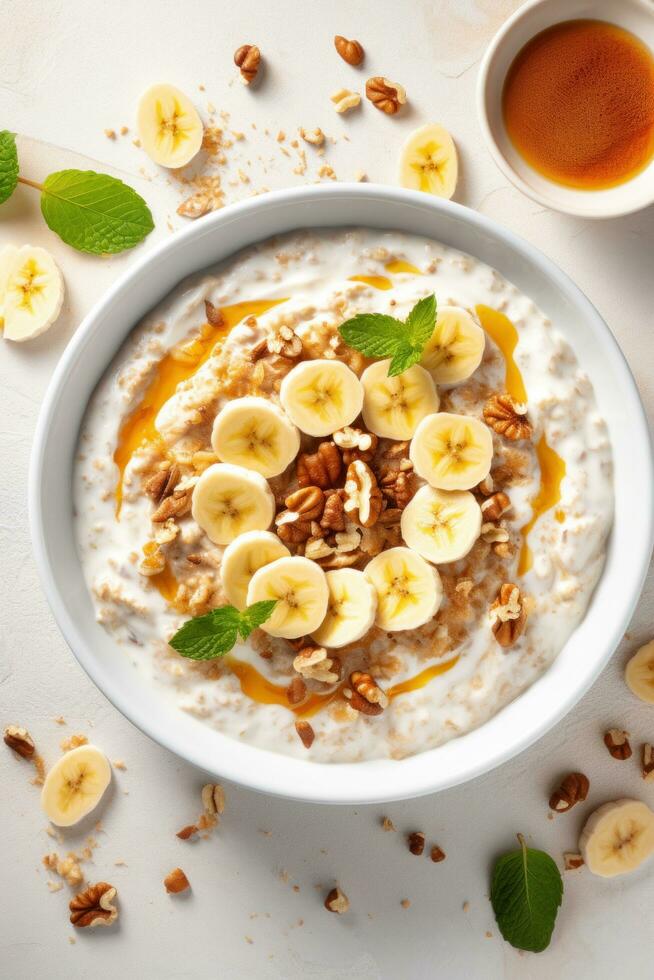 AI generated A bowl of creamy oatmeal with sliced banana, honey, and chopped walnuts photo