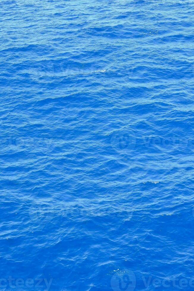 the ocean is blue and has ripples on it photo